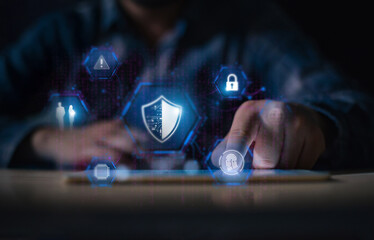 Cyber security concept. Person using tablet with virtual shield and lock icons to protect data, privacy, and network from cyber attacks and viruses.