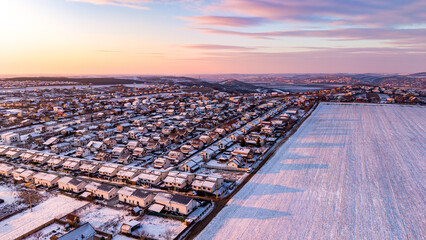 Aerial view of winter farmland and residential area in Miroslava, Iasi, Romania