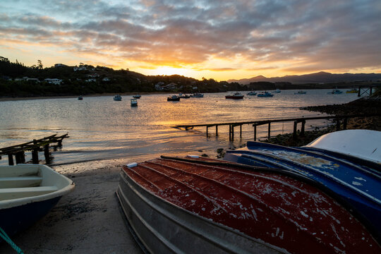 Boats on moorings at sunset in Moeraki Bay