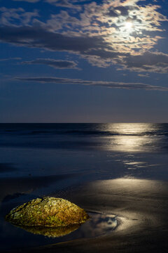 Moeraki boulders on beach at dusk with bright moon