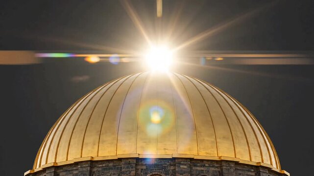 Static shot of a polished golden dome against a dark grey sky. A natural sun lens flare peaks from behind the metallic surface with ray-traced reflections in 4K