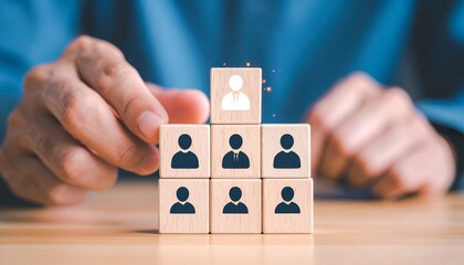 Wooden block pyramid showing hierarchy, topped by a white cutout figure