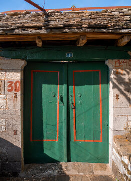 Vintage wooden door in a traditional house in a mountain village in Greece
