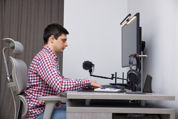 Man using computer and graphic tablet for his remote work at home office
