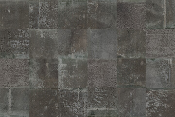 black grunge blocks background.Old cement squares wallpaper