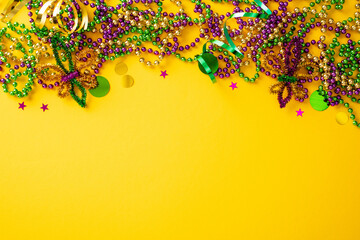 Mardi Gras top border with colorful beads and confetti on a yellow background.
