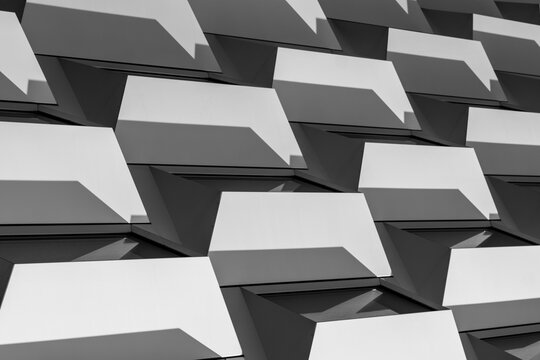 Modern architecture abstract facade design with white blocks pattern and geometry creating shadow depth for contemporary exterior background