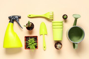 Gardening tools with rake, shovel and  watering can on beige background. Top view © Pixel-Shot