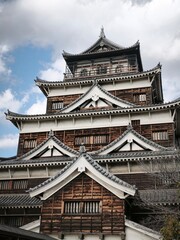 Traditional Japanese Castle Architecture with Dramatic Cloudy Sky