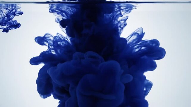 Blue Ink Cloud Dissolving in Water, Abstract Explosion of Color and Movement