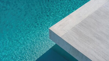 Obraz premium A white concrete platform extends over clear turquoise water, viewed from above. Concept Aerial View Photography, White Concrete Platform, Turquoise Water, Minimalist Seascape, Overhead Perspective