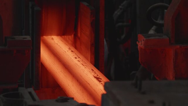 Hot steel billets moving along production line in foundry