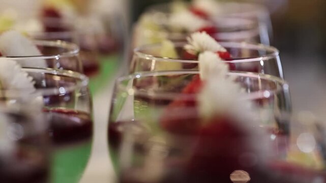 Macro refocus shot showing mint dessert cups with raspberries served in elegant glasses on a refined event table
