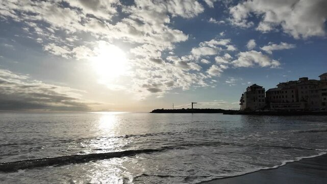 soft waves roll onto sandy beach in winter coastal village bogliasco in slow motion 120fps