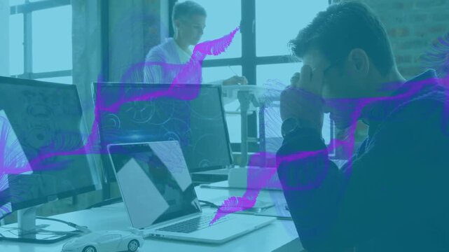 Animation of abstract pattern moving over caucasian male employee wearing glasses and using laptop