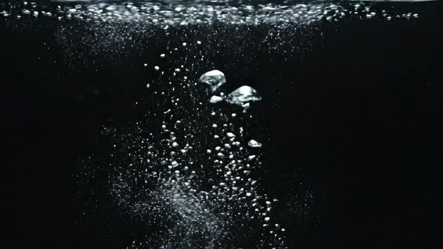Bubbles rising up in dark water