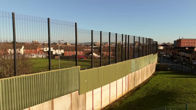 4K 60FPS aerial video of the Belfast Peace Wall Interface structure in Belfast, Northern Ireland. The murals explore the politics of NI and worldwide. Produced with Rec709 color.