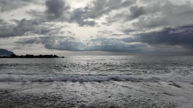 soft waves roll onto sandy beach in winter coastal village bogliasco in slow motion 120fps