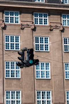 Classic city facade and architecture frame a street intersection where traffic signal displays stop guiding urban mobility and keeping movement safe