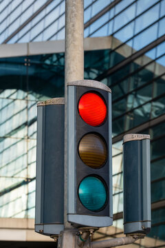 Modern pole signal shows red stop control at urban street intersection for traffic safety and smart mobility in contemporary city setting