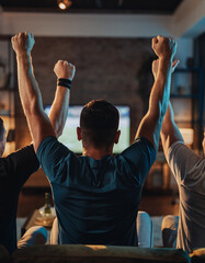 Friends watching sports on TV celebrating victory