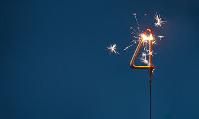 4 years celebration festive background with copy space made with Bengal fire in the form of number Four.