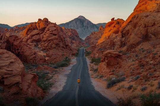 Man walking along scenic desert road in Valley of Fire, Nevada