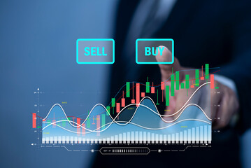 Businessman interacting with stock market diagrams, hologram with lines and candlesticks, and buy sell buttons. concept of trading and financial analysis.