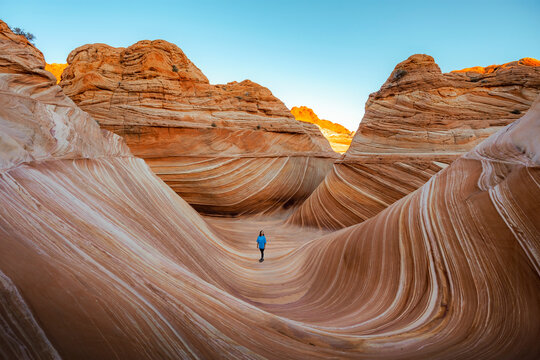 Woman hiking through the Wave rock formation in Arizona