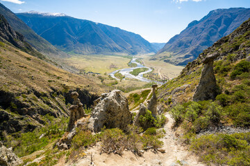 View of Chulyshman valley and river through stone mushrooms in Altai Russia Unique natural landscape with rock formations and flowing water