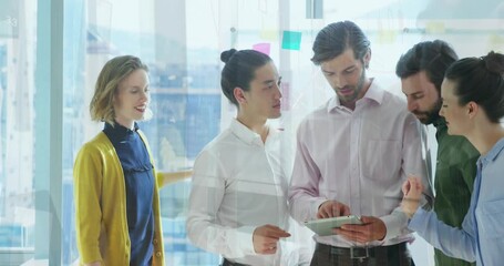 Animation of data processing against diverse businesspeople discussing over digital tablet at office - Powered by Adobe