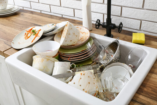 Sink with dirty dishes in kitchen