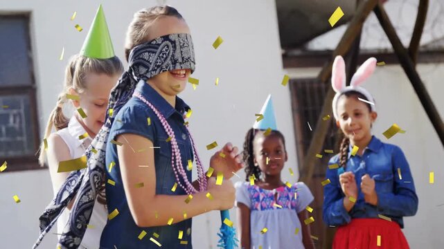 Children playing party game with confetti animation over outdoor celebration