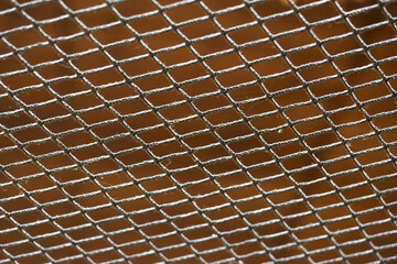 Sturdy grey steel mesh texture with diamond pattern grid showing strong industrial construction and...