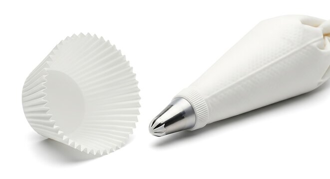 Baking supplies including a cupcake liner and a piping bag with a metal tip on a white background.