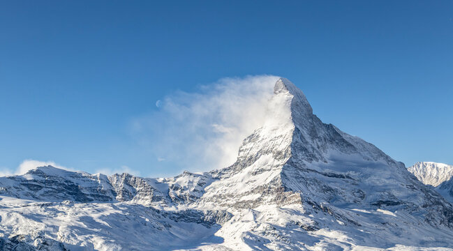 Matterhorn and Cervino mountains covered with snow under clear blue sky in winter season at Zermatt Switzerland