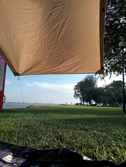 Camping by the beach with green grass  © Syifa Ghani