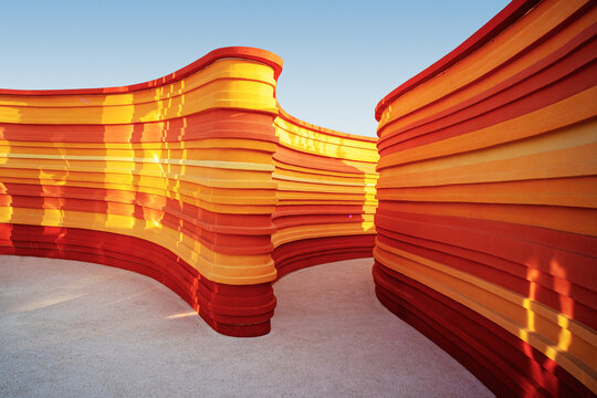 Winding orange layered walls in a park - Rhythm concept