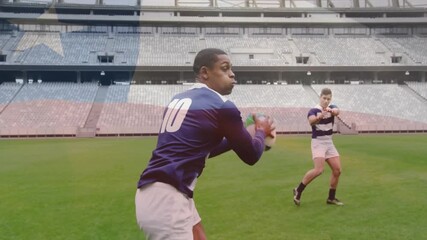 Practicing rugby, players running and passing ball on green field in stadium