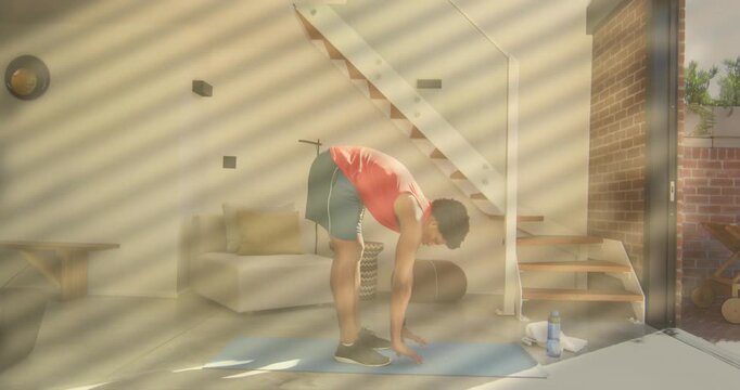 Man shifting weight on blue yoga mat and initiating forward fold using animated guides for fitness