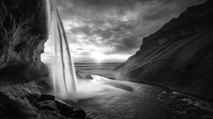 Dramatic landscape shot of a powerful waterfall surrounded by clouds.