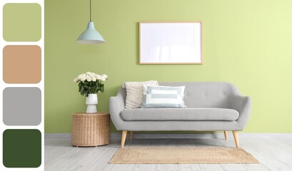 Interior of living room with grey sofa, basket and white roses in vase. Different color patterns