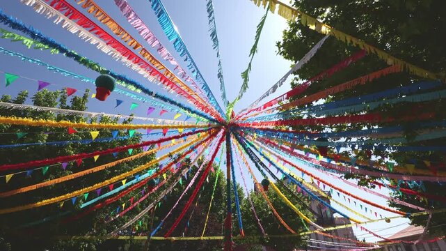 Colorful ribbons and flags overhead at street festival