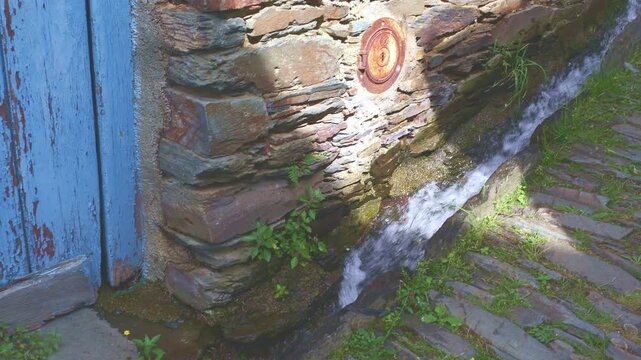Mountain stream water flowing through a channel in the traditional Portuguese mountain village of Piodao.