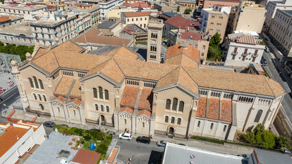 Side view of Reggio Calabria Cathedral, in Italy. It is a Roman Catholic cathedral in the historic center of the city. Its dedication is to the Assumption of the Virgin Mary. It is a sunny morning.