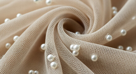Beige mesh fabric adorned with delicate white pearls, elegantly folded to showcase its luxurious texture and intricate details.