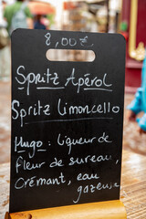 Chalkboard bar menu offering various spritz drinks in Colmar