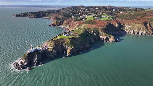 Baily Lighthouse landmark on papular Howth Cliff Walk in Dublin, Ireland. Drone panoramic