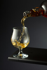 Cognac or brandy being poured into a glass.