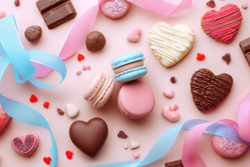 Valentine's themed flat lay of sweets: macarons, chocolates, heart-shaped cookies, ribbons, soft pastel background, commercial food photography